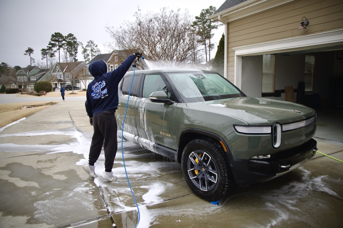 Charlie washing a truck with a pressure washer